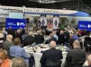 In the shadow of the Special Air Missions aircraft that previously served as Air Force One, ARRL donors gathered to kick off activities at Dayton Hamvention. ARRL Director of Development Kevin Beal, K8EAL, addresses the crowd. [Bob Inderbitzen, NQ1R, photo]